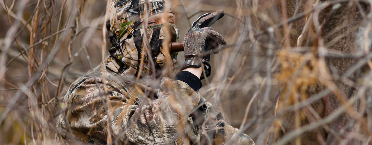 Camouflage man with Duck Call in the wild